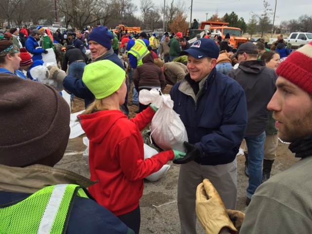 Volunteers load sand bags for the River Des Peres Levee